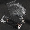 A transparent PVC jewelry pouch with a zip lock closure is shown alongside several stacked pouches and a beaded necklace.