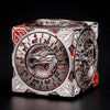 A metallic, multi-function dice cube featuring a dragon design and numbered faces, set against a dark background.