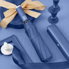 A blue automatic foldable umbrella with an orange ribbon is shown next to a navy blue surface and a gavel.