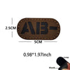 A dark brown glow-in-the-dark blood type tactical patch with hook and loop backing