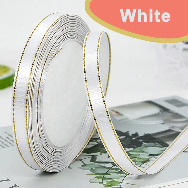 White gold-edge satin ribbon rolled and unwound for crafts gift wrapping and wedding decor