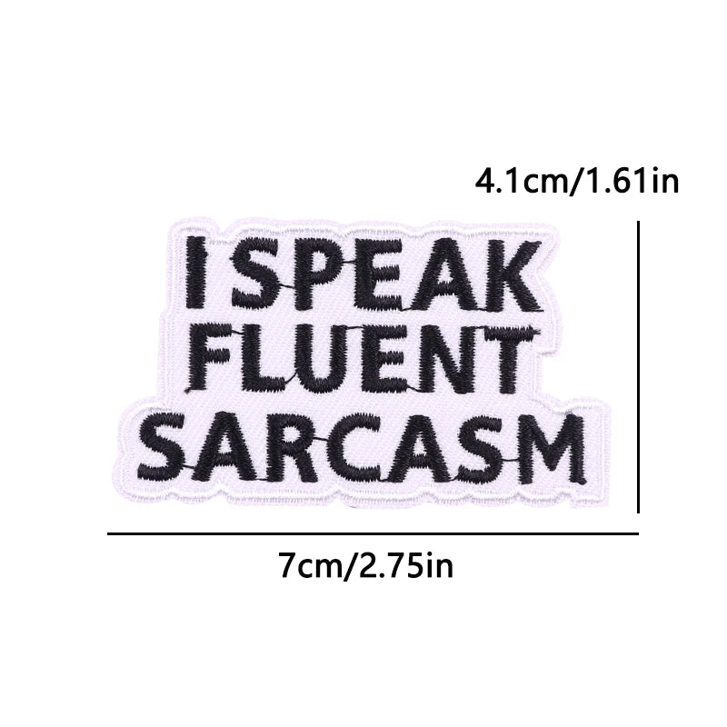 Black embroidered iron-on letter patch with the text SPEAK FLUENT SARCASM