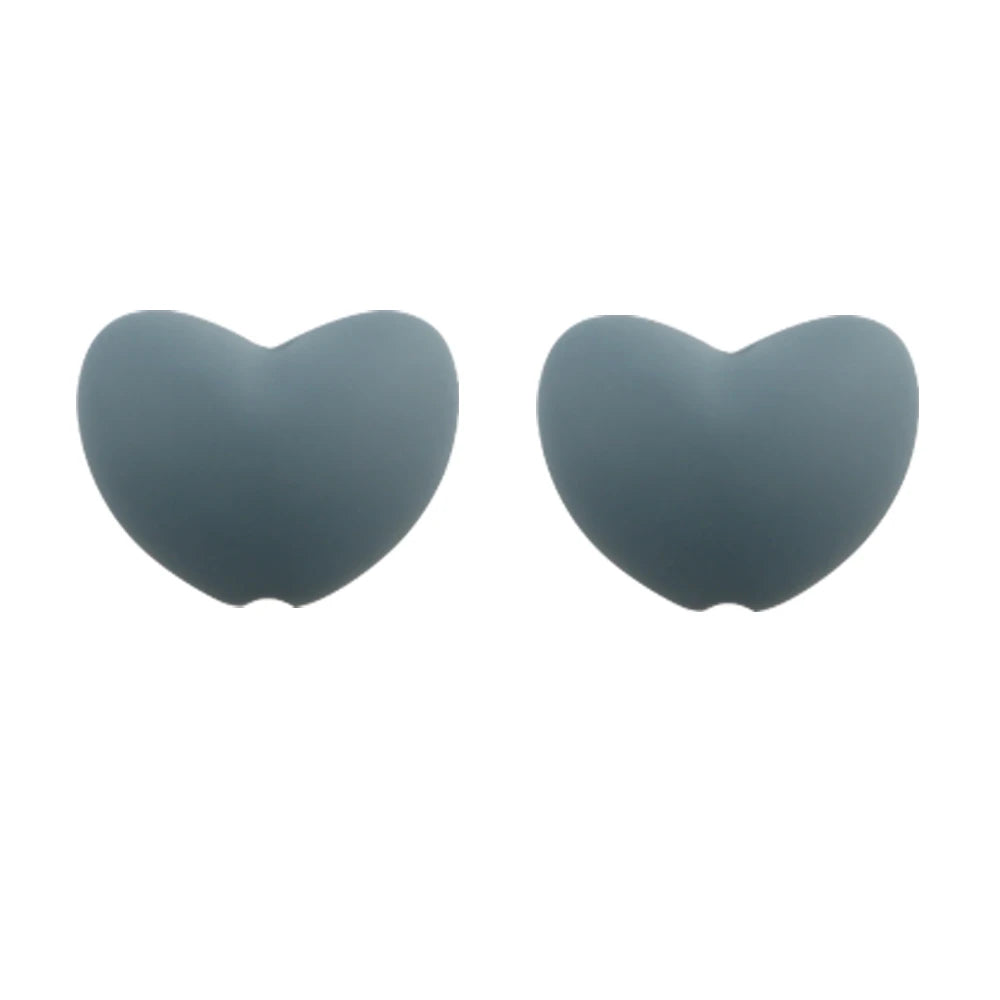 A pair of smooth, heart-shaped silicone beads in a muted gray color.