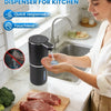 A woman uses a black touchless automatic soap dispenser for kitchen cleaning.