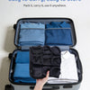A hand is holding an open black storage box containing folded blue seat cushions and a white shirt.
