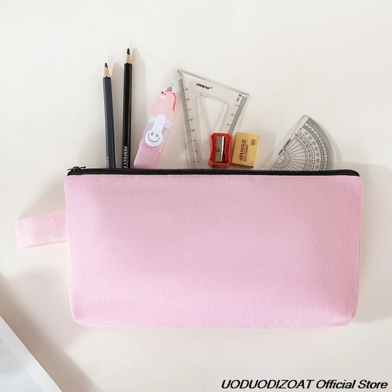 A pink zippered pouch containing various tools like pencils, a ruler, and a small box on a white background.
