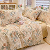 A beige floral printed duvet cover set with matching pillows displayed on a bed.