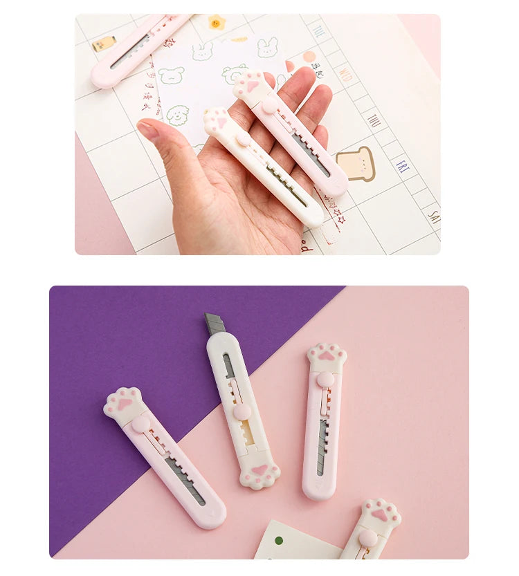 Eine Hand hält ein rosa Mini-Klaue-Werkzeugmesser für Basteln und Dekoration neben einem Blatt Papier.