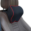 Black memory foam car headrest neck pillow with a red trim placed on a brown leather seat.