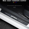 Close-up of a black wear-resistant leather door sill protector installed on a white vehicle frame.