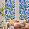 A close-up of a floral stained glass window film featuring blue and green flowers on a light background.