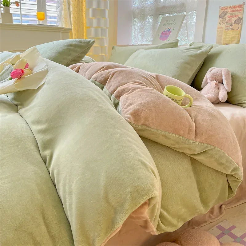 A close-up of a cozy milk velvet bedding set featuring a duvet cover and pillows in soft green and pink tones.