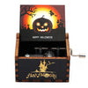 A wooden music box with a Halloween theme featuring a carved pumpkin and castle silhouette.