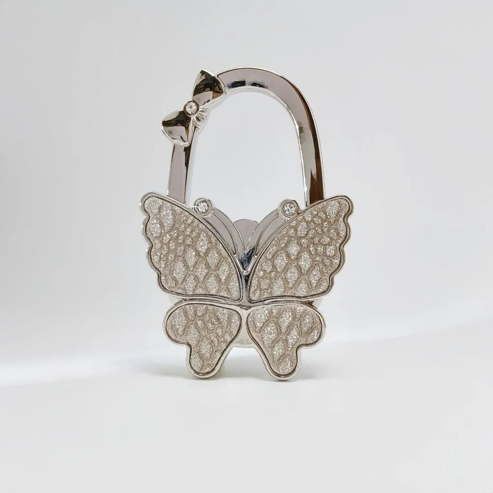 Silver foldable butterfly shaped handbag hook with sparkling details