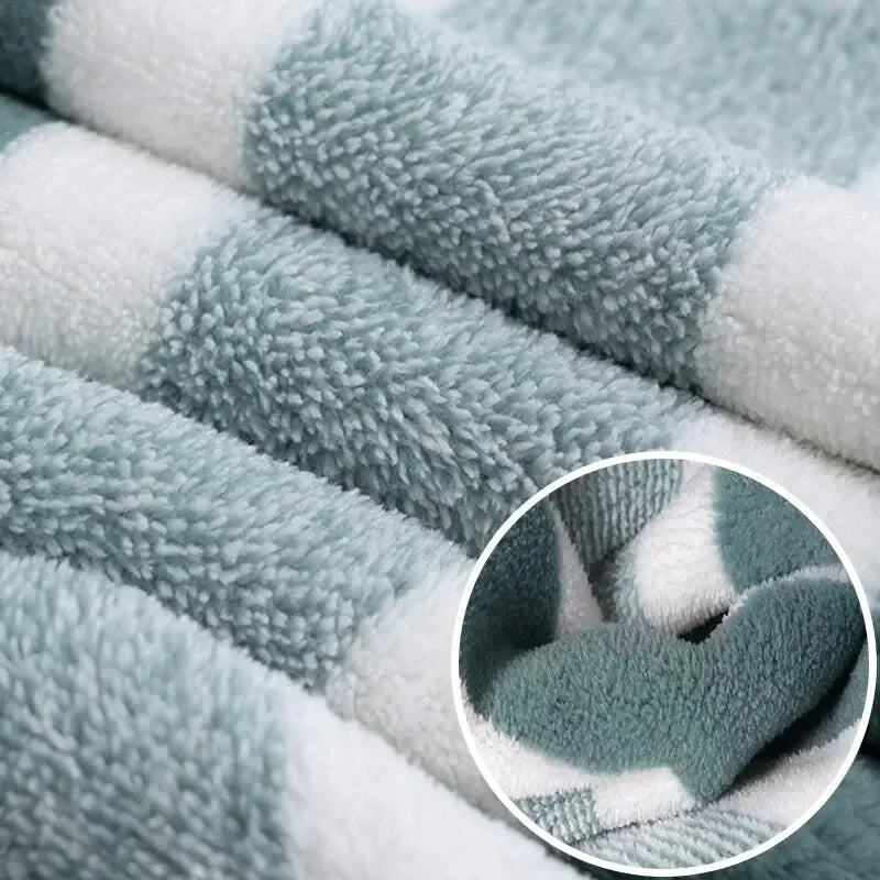 Close-up of a striped microfiber towel set showing gray and white textures.