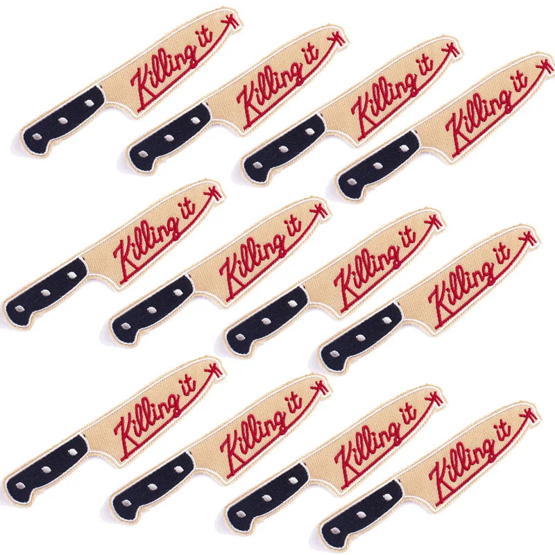 A set of ten embroidered iron-on patches featuring a skull and horror design with red stitching on a tan background.