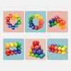 A collection of colorful, round fidget balls in various shades of red, yellow, green, and blue arranged in heart shapes and c