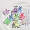 A collection of clear and colored acrylic alphabet beads for jewelry making displayed on a white plate.