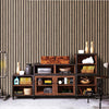 A dark wood shelving unit with multiple compartments and drawers against a textured wall.
