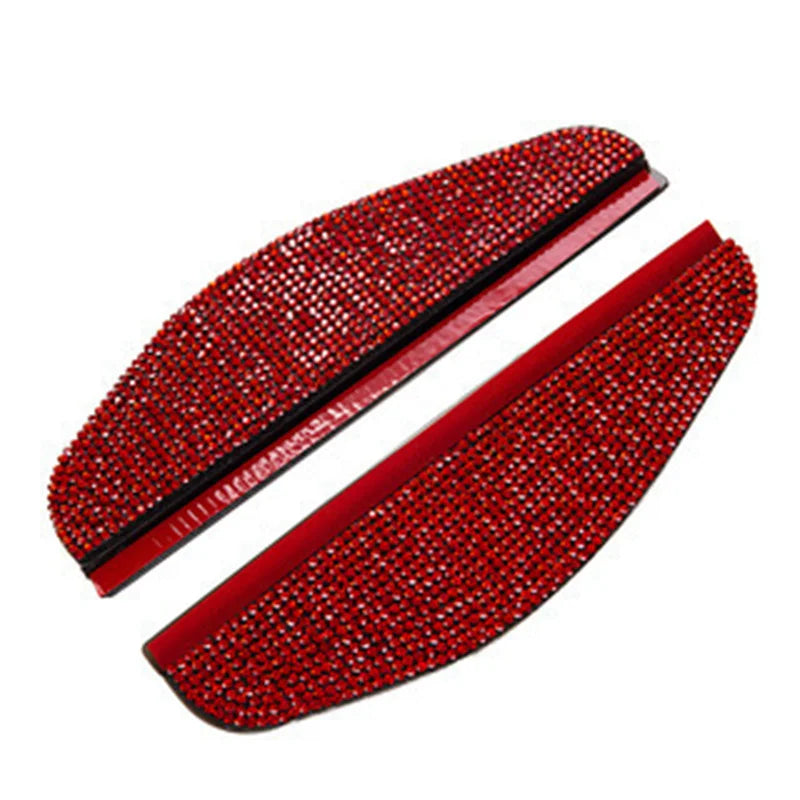 A pair of red rhinestone car rearview mirror rain guards.