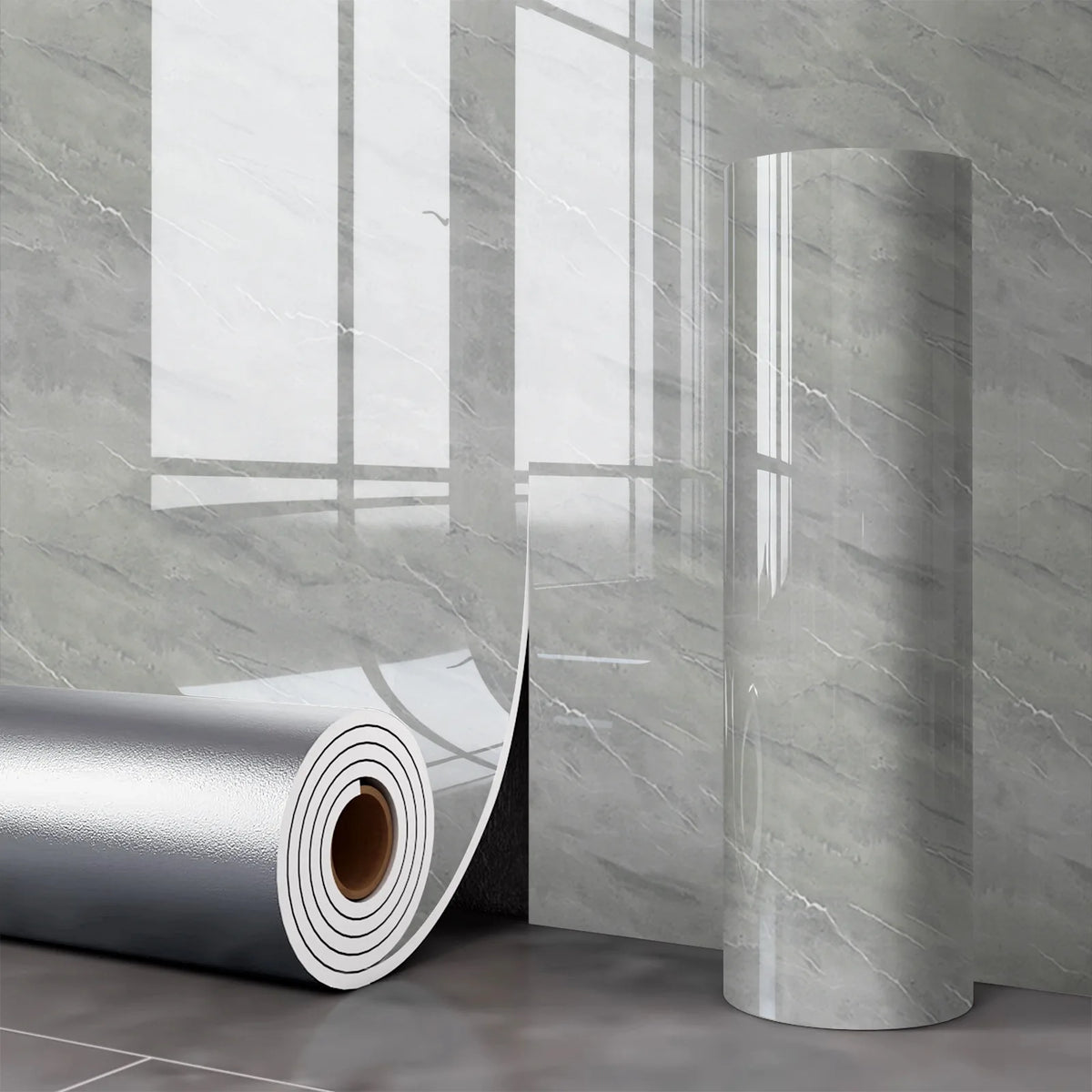 A roll of self-adhesive marble wall sticker for kitchen and bathroom displayed next to a gray marble wall.