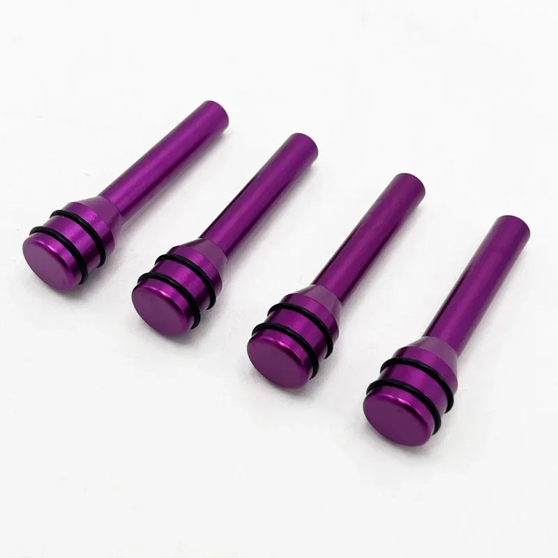 Four shiny purple aluminum alloy car door lock pins displayed on a white background.
