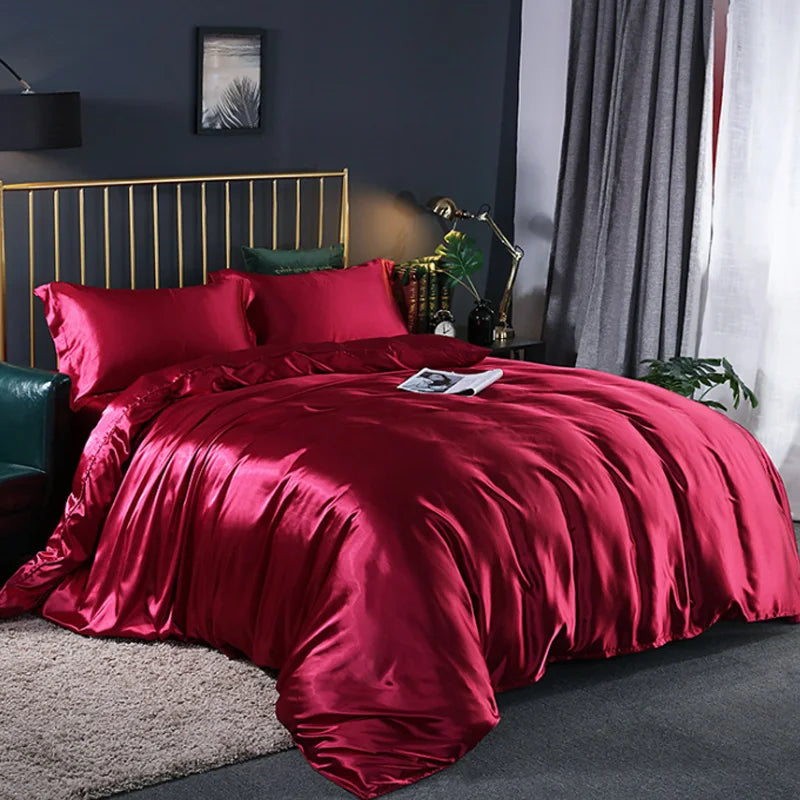 A luxurious deep red silky duvet cover set displayed on a bed with dark gray walls and curtains.
