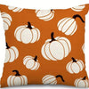 Orange pumpkin pattern pillow covers featuring white pumpkins on a neutral fabric.