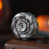 A close-up shot of a silver stainless steel fidget spinner resting on a dark wooden surface.