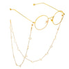 Gold-toned eyeglasses with thin metal arms and a delicate chain featuring star and moon pendants