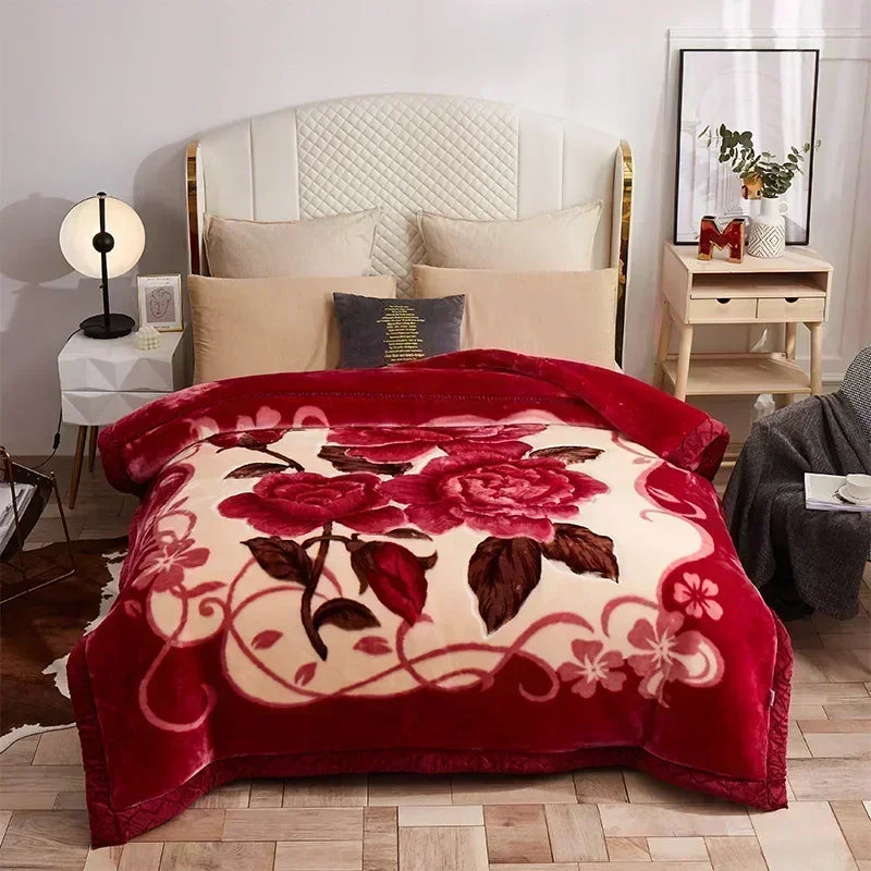 A deep red weighted plush blanket featuring a large floral pattern on a white background.