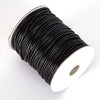 A spool of black waxed cord rope used for jewelry making and DIY projects.