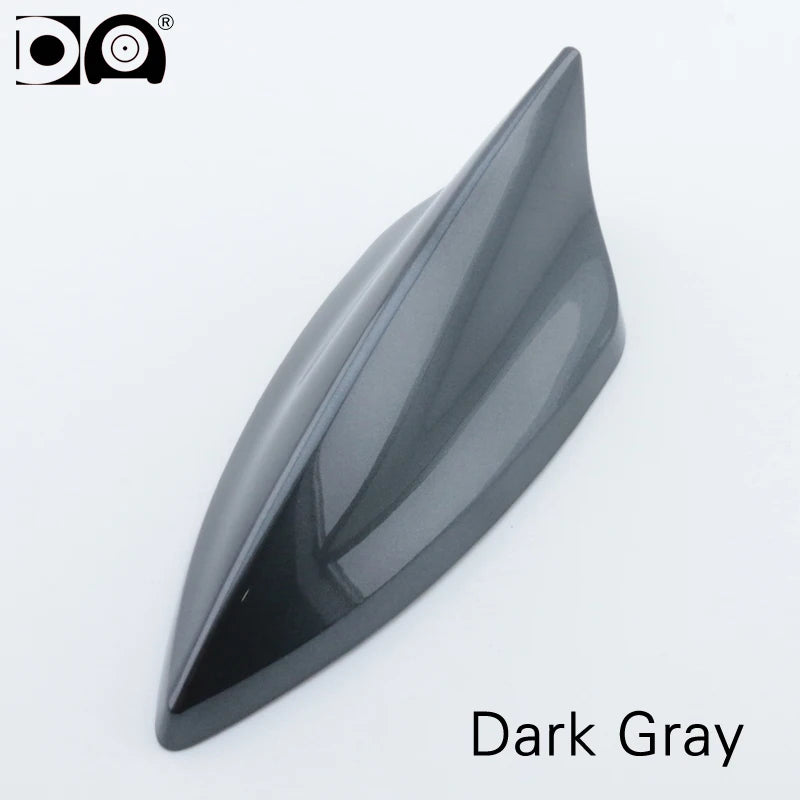 A sleek, dark gray shark fin car antenna with a glossy finish.