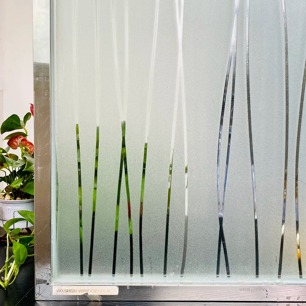 Frosted stripe privacy window film displayed in a glass panel with vertical stripes.