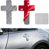 Three flag cross emblems in silver, red, and silver metal are shown next to a blank silver emblem on a car surface.