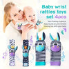 A set of four baby wrist rattles and teether socks in black and purple stripes with musical notes.