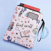 Pink fabric book sleeve with a cat and book nerd design featuring various stationery items and a zipper.