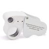 A white dual-magnification LED loupe with a foldable design and a separate identifying tag.