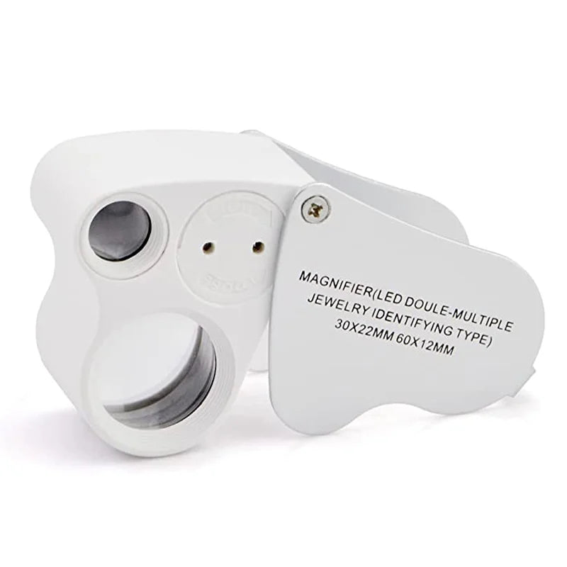 A white dual-magnification LED loupe with a foldable design and a separate identifying tag.