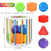 A set of six colorful cylinders and rattles for Montessori play, including a ball and shape sorter.