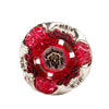 A red spinning top made of alloy with intricate floral patterns and silver-toned metalwork.