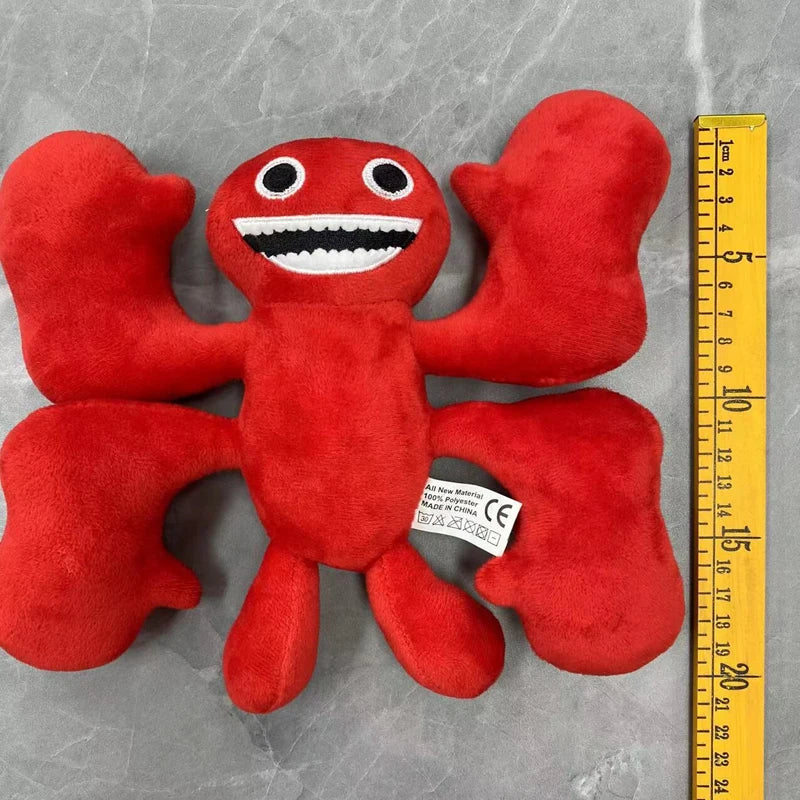 A bright red plush toy of an Opila Bird character with a smiling face and outstretched arms.