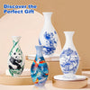 A collection of white porcelain vases with blue floral designs displayed on a light background.