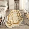 A beige area rug with swirling gold lines rests on a light wood floor next to a bed and a white shelf.