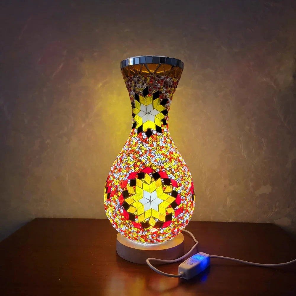 A handcrafted Turkish mosaic table lamp with a vibrant, colorful glass base and warm LED glow.