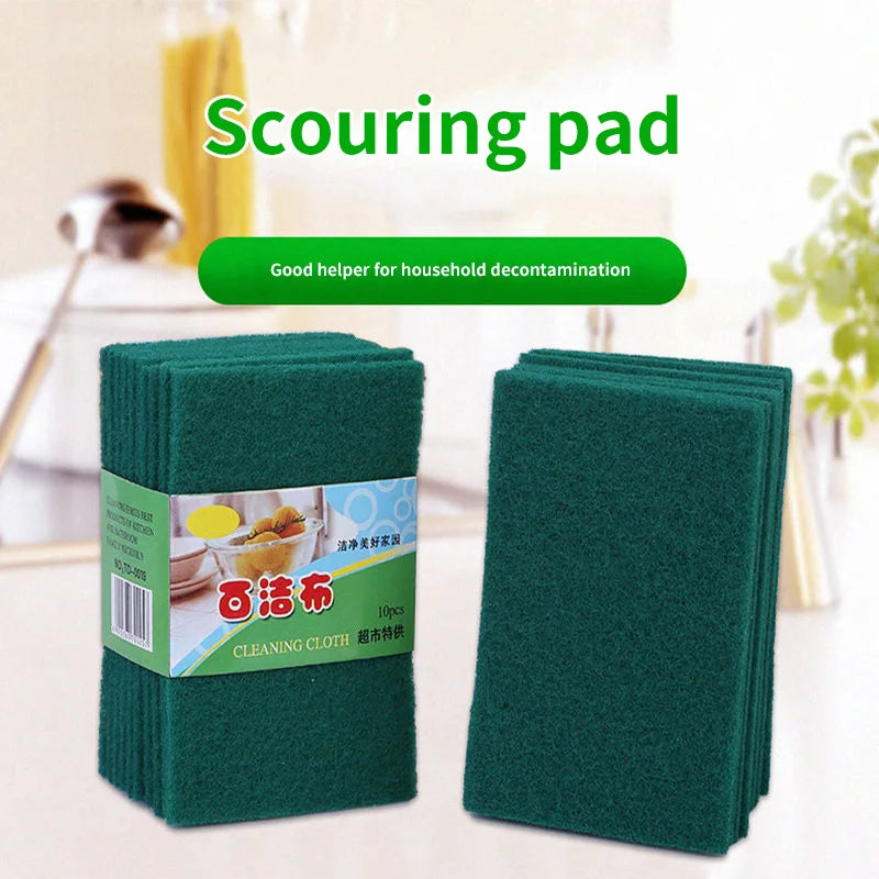 A stack of green scouring pads or cleaning cloths is shown on a white surface.