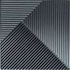 A close-up view of black, ribbed 3D diamond wall panels arranged in a sharp diagonal pattern.