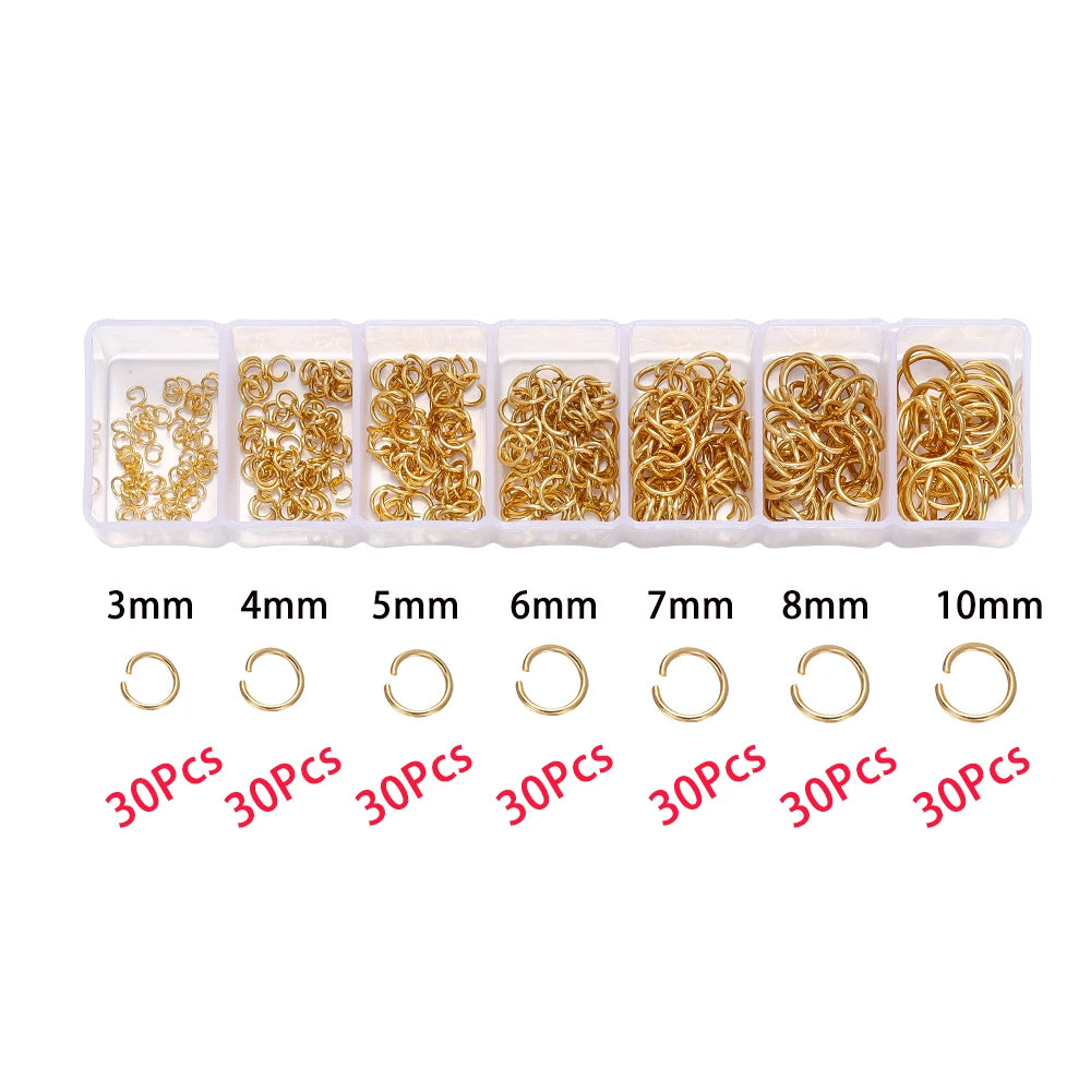 A set of gold-colored jump rings and crimps packaged in clear plastic compartments with labeled sizes from 3mm to 10mm.