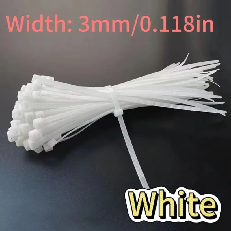 White heavy-duty self-locking nylon cable ties with a 3mm width shown on a dark surface.