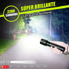 A hand holds a bright aluminum casing flashlight emitting a strong beam in a nighttime outdoor setting.